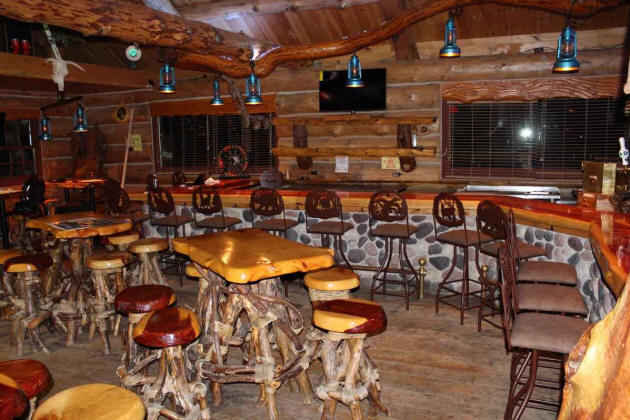 commercial bar in a rustic lodge setting shown Grace bar stools bases and the bar surface height