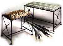 2 wrought iron benches with tiger and leopard fabric